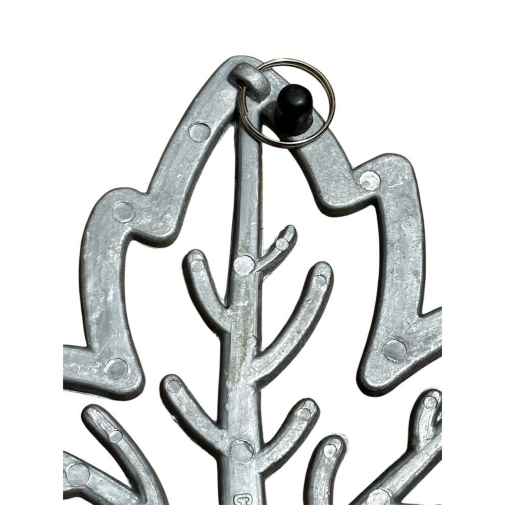 Copco cast aluminum heat resistant trivet featuring a maple leaf design. - Picture 3 of 4